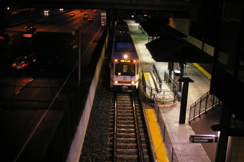 An RTD light rail train at Arapahoe at Village Center station at night